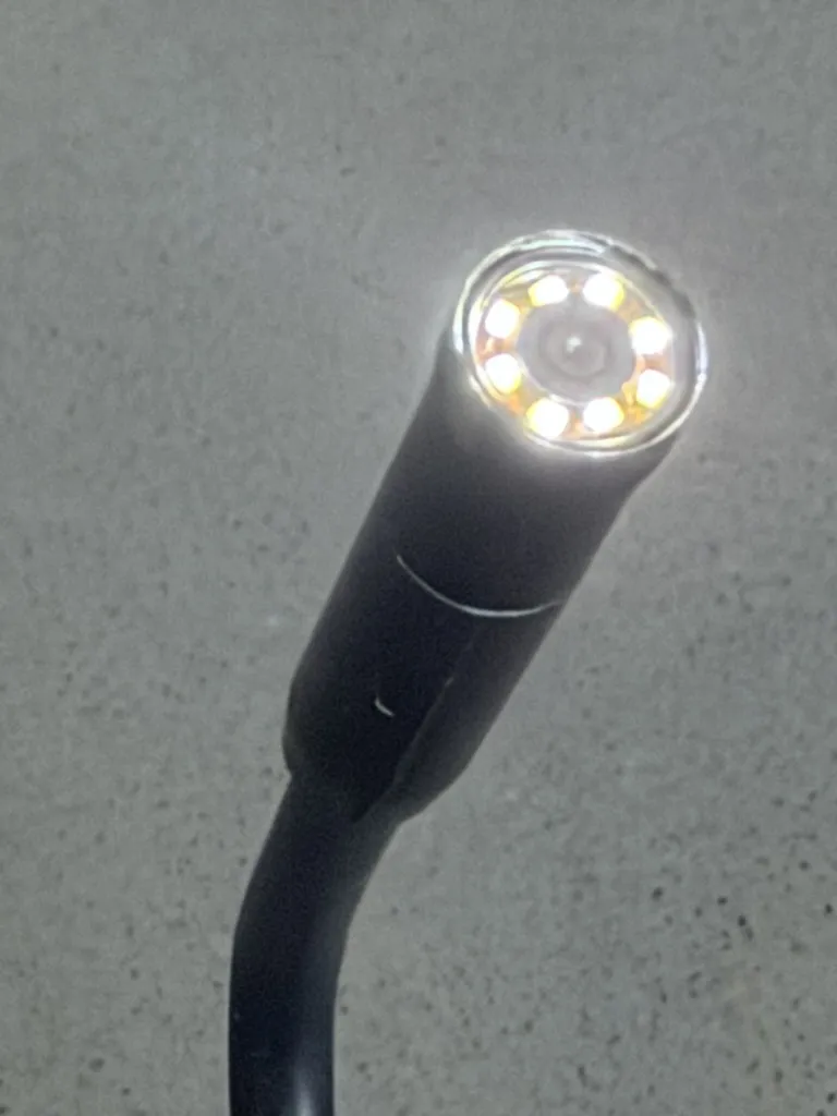 Close-up of the working camera tip with a ring of LEDs around the lens