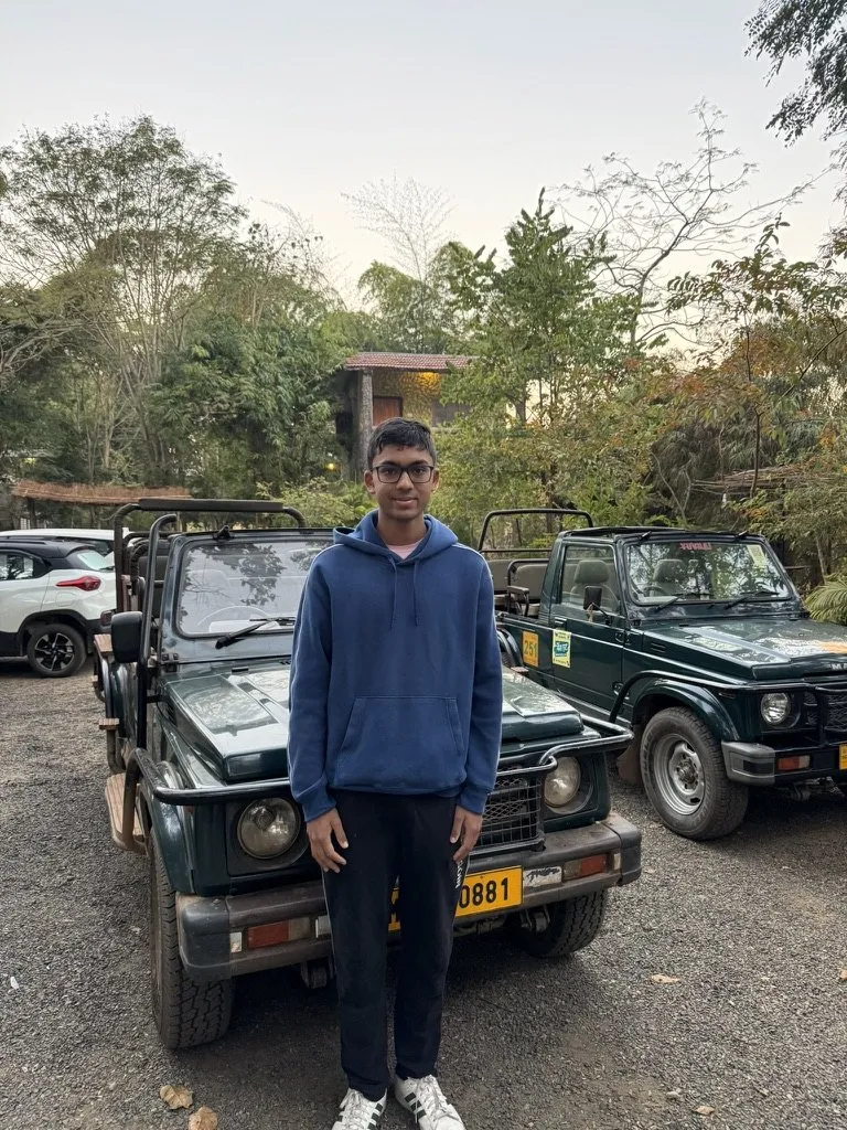 Aditya standing between two open safari jeeps at Kanha National Park
