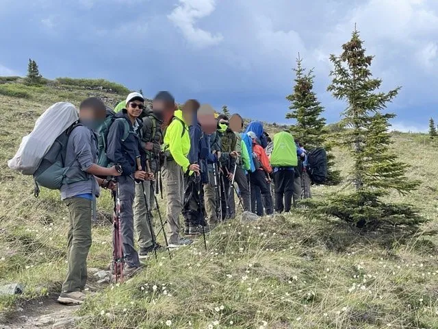 Aditya with Troop 685 on an Alaska backpacking trail; other faces are blurred