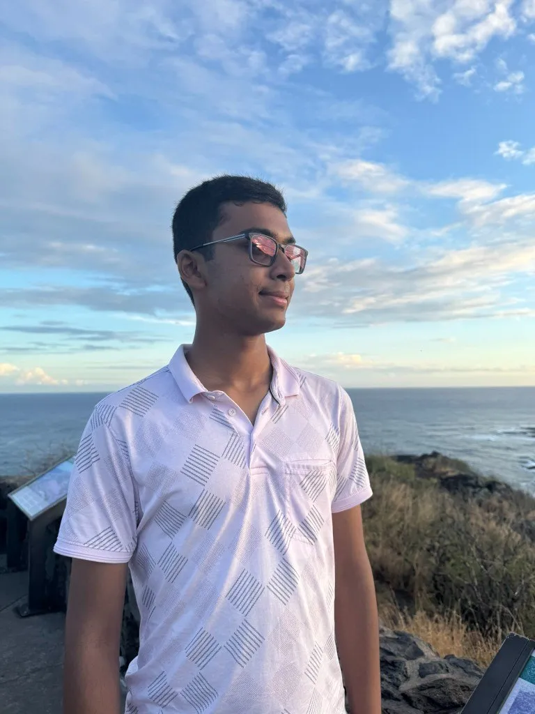 Portrait of Aditya at an ocean overlook at sunset