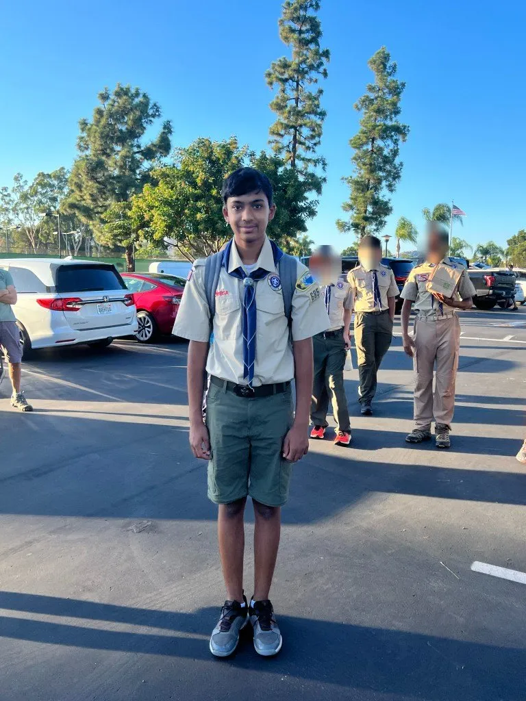 A younger Aditya in scout uniform before a troop outing